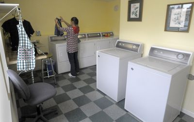 Barbara Bishop folds laundry at Our Place Community Ministries Tuesday. A $270,000-renovation was just completed at the facility, and after suveying its clients, found that laundry was the most important service they could offer.  (CHRISTOPHER ANDERSON / The Spokesman-Review)