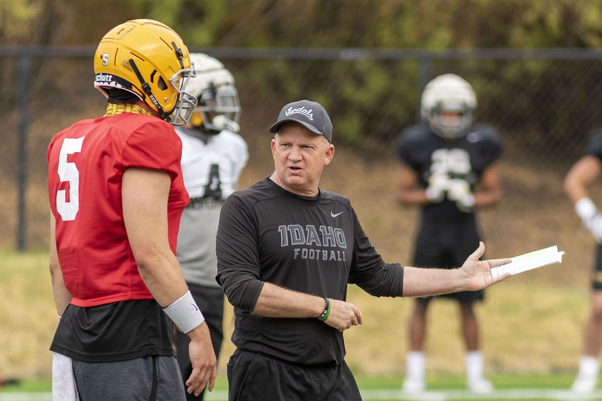 Coach Paul Petrino offers tips to 6-foot-5, 248-pound senior Mike Beaudry, one of four quarterbacks who started for Idaho during the spring season.  (Geoff Crimmins/For The Spokesman-Review)