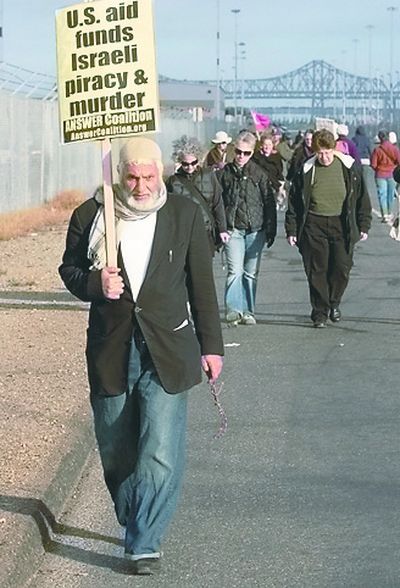 Demonstrators  picket the entrance to the SSA facilities at the Port of Oakland, Calif., on Sunday.  (Associated Press)