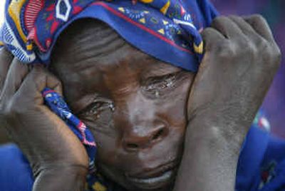 
A Sudanese refugee cries moments after she and her family reached the safety of Bahai on the Chad border Friday. They had been hiding in the hills in Darfur province for nearly a year before they reached the border. 
 (Associated Press / The Spokesman-Review)