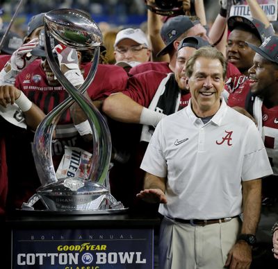 Alabama coach Nick Saban pauses next to the Field Scovell Trophy after his team's Cotton Bowl NCAA college football semifinal playoff game against Michigan State on Dec. 31, 2015, in Arlington, Texas. Alabama won 38-0 to advance to the championship game.