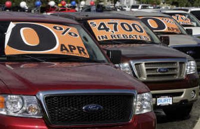 
Unsold 2007 F-150 pickup trucks are adorned with placards to advertise a low interest rate as well as available rebates at a Ford dealership in the southeast Denver suburb of Centennial, Colo. Associated Press
 (Associated Press / The Spokesman-Review)