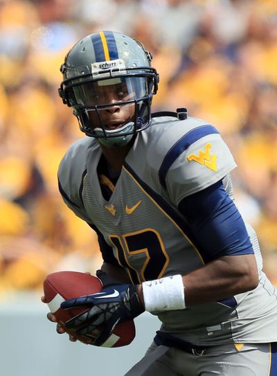 West Virginia’s Geno Smith threw for 330 yards and 3 touchdowns on Saturday. (Associated Press)