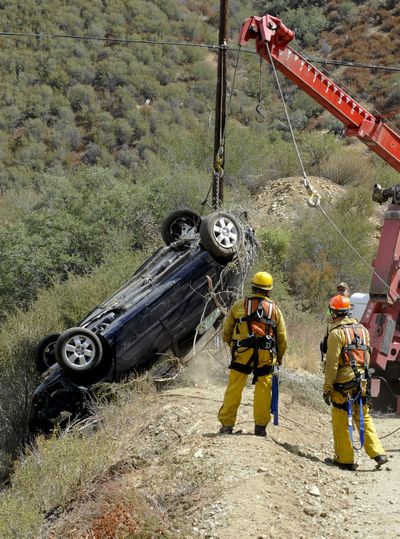 The car of a man who survived for five days after his car plunged 200 feet off a a remote mountain is recovered in Castaic, Calif., Friday, Sept. 30, 2011 . Close to a week after his car plunged 200 feet into a ravine, David Lavau, 68, was rescued Thursday by his three adult children, who took matters into their own hands after a detective told them his last cellphone signal came from a rugged section of the Angeles National Forest. (Gus Ruelas / Fr157633 Ap)