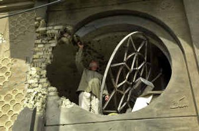 
An Iraqi inspects damage at a mosque in Fallujah on Monday after U.S. troops pounded the insurgent-held city with airstrikes and tank fire overnight. 
 (Associated Press / The Spokesman-Review)