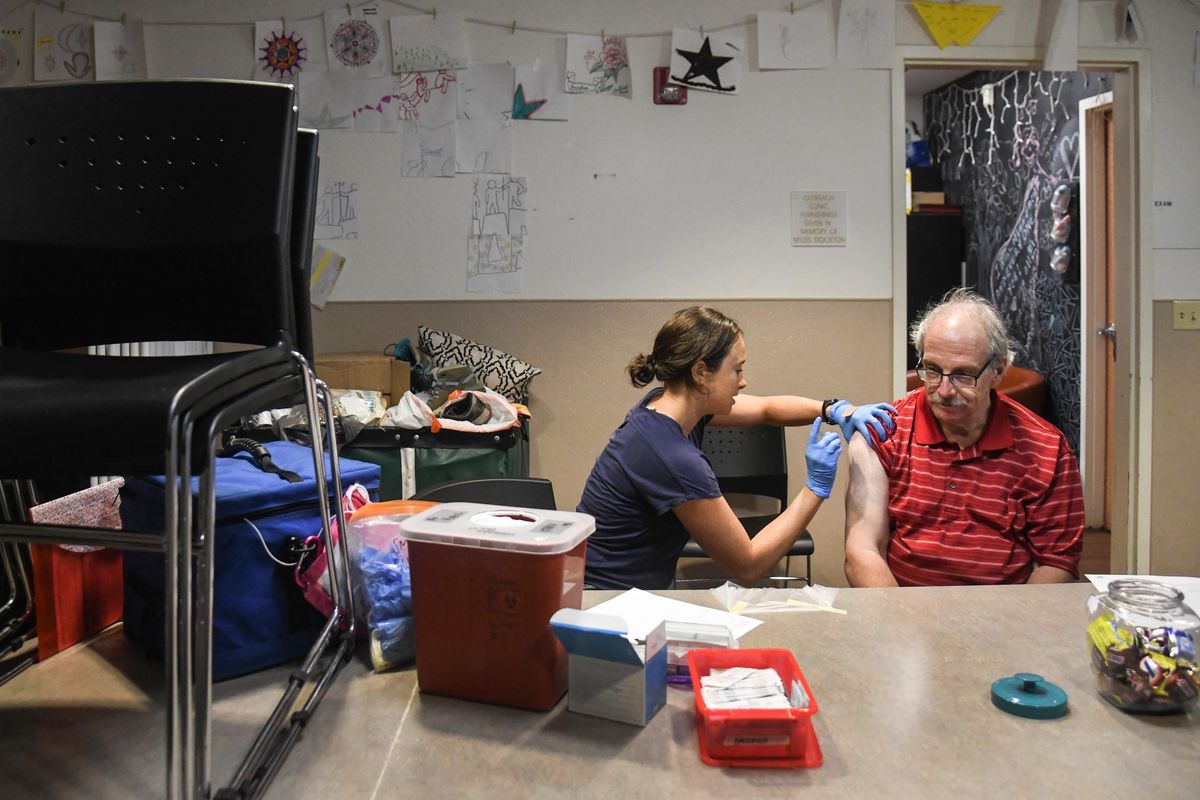 Spokane Regional Health District nurse Kira Lewis, left, administers a hepatitis vaccination to Chris Keyser, 60,, Tuesday, Aug. 6, 2019, at the House of Charity in Spokane, Wash. (Dan Pelle / The Spokesman-Review)
