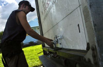 
Jason Sterling closes the back door of a St. Vincent de Paul truck after picking up donated items Friday afternoon. High gas prices have put a strain on some service organizations. 
 (Holly Pickett / The Spokesman-Review)