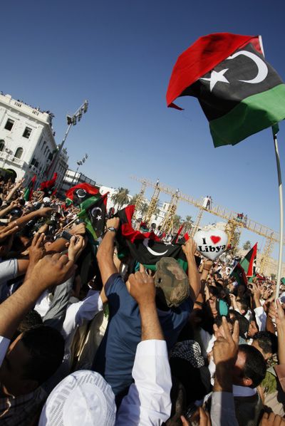 Libyans gather in the former Green Square in Tripoli, renamed Martyr’s Square, as they mark the end of Ramadan and celebrate the absence of Moammar Gadhafi. (Associated Press)