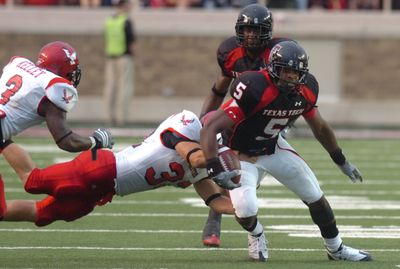 Tech’s Michael Crabtree breaks free from EWU’s J.C. Sherritt.  (Associated Press / The Spokesman-Review)