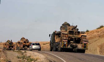 
Turkish military trucks carry tanks toward Sirnak near the Turkish-Iraq border Tuesday. Turkey said it has begun preparations for a military operation into Iraq to chase Kurdish rebels. Associated Press
 (Associated Press / The Spokesman-Review)