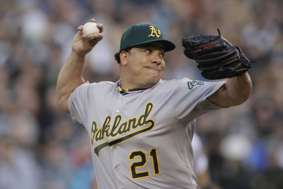 Oakland starting pitcher Bartolo Colon was dominating against the Mariners in Seattle’s home opener on Friday. (Associated Press)