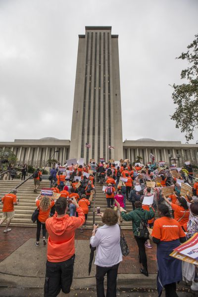 About 1,000 protesters wearing orange T-shirts with the hashtag #gunreformnow  hold a rally Monday, Feb. 26, 2018, on the steps of the Florida Capitol in Tallahassee, Fla. The demonstration was led by former Miami Beach Mayor Philip Levine, who's a Democratic candidate for Florida governor. (Mark Wallheiser / AP)