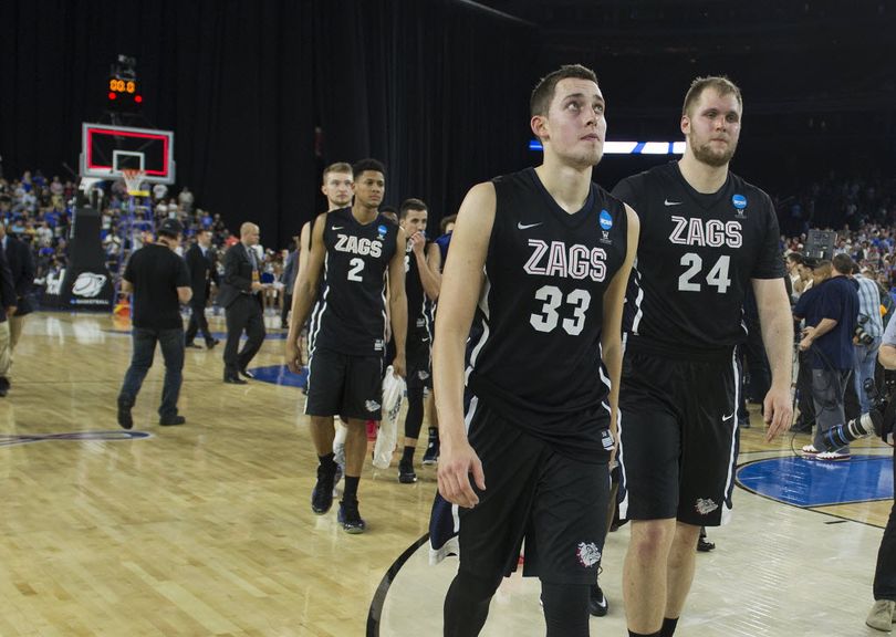 Gonzaga forward Kyle Wiltjer (33) looks up at the scoreboard one last time and exits the court with Gonzaga center Przemek Karnowski (24) after Duke beat the Zags 66-52, Sunday, March 29, 2015, in Houston, Texas. COLIN MULVANY colinm@spokesman.com  
 (Colin Mulvany)