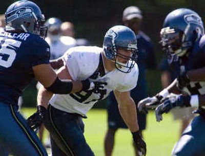 
With 58 sacks in 121 career games, Patrick Kerney, center, seems an ideal fit to energize the Seattle pass rush.  Associated Press
 (Associated Press / The Spokesman-Review)