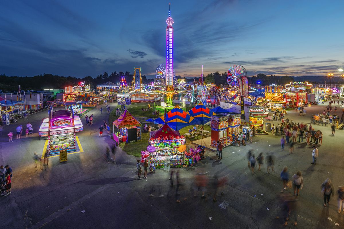 In this Aug. 9, 2018 photo, fair-goers attend The State Fair of West Virginia at the State Fairgrounds in Fairlea, W.Va. West Virginia has seen a higher percentage of residents depart than any other state in the past decade. (Craig Hudson)