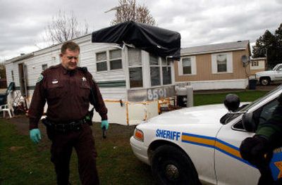 
Sheriff's Deputy Jack McAvoy leaves the trailer after possible explosives and drug paraphernalia were reportedly removed. 
 (Kathy Plonka / The Spokesman-Review)
