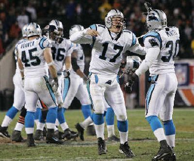 
Jake Delhomme (17) and Mike Minter celebrate the victory. 
 (Associated Press / The Spokesman-Review)
