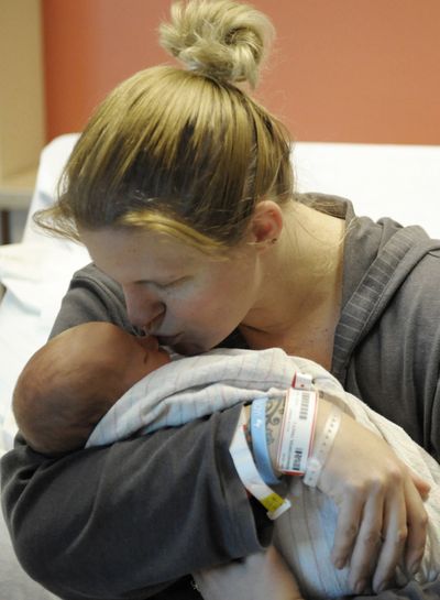 Tracy Hermanstorfer kisses her newborn son, Coltyn, Monday, at a hospital in Colorado Springs, Colo.  (Associated Press)