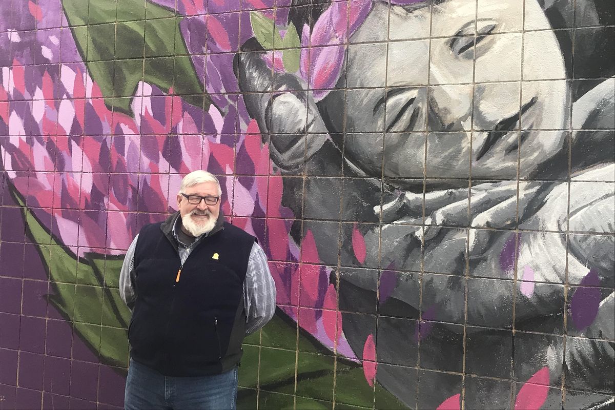 Director Dave Richardson stands next to a mural painted on the outside of the Northeast Community Center in the Hillyard Neighborhood in northeast Spokane. (Nina Culver / The Spokesman-Review)