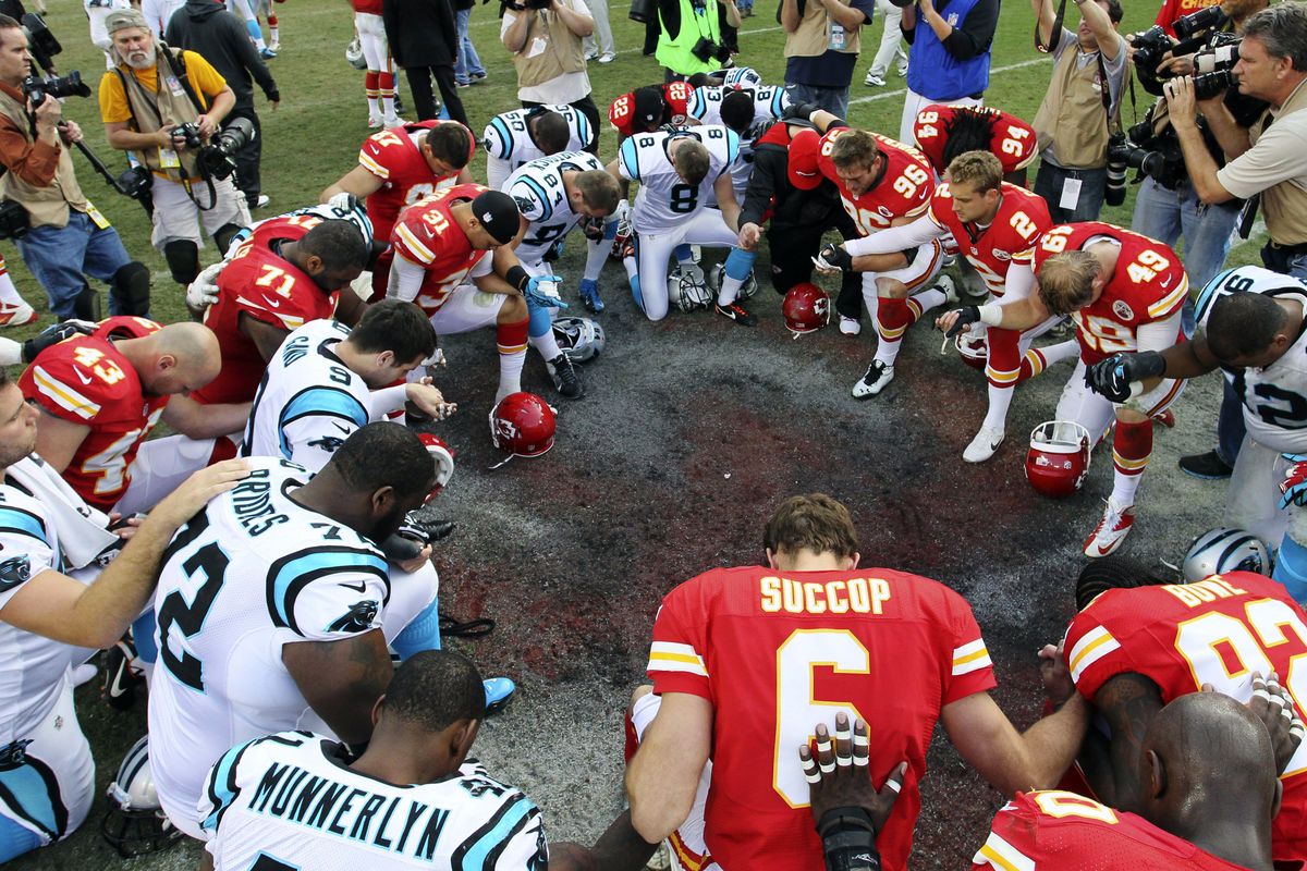 Members of the Kansas City Chiefs and Carolina Panthers pray together following an NFL football game at Arrowhead Stadium in Kansas City, Mo., Sunday, Dec. 2, 2012. The Chiefs won 27-21. (Colin Braley / Fr123678 Ap)