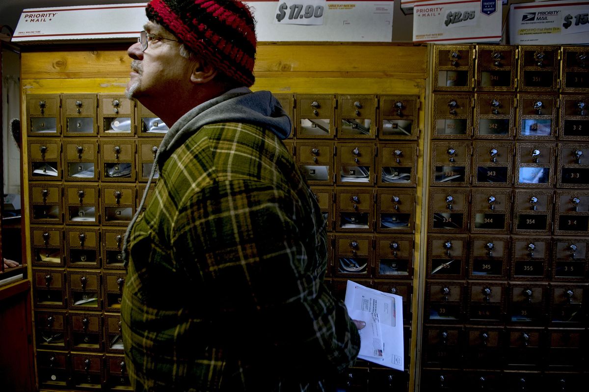 Kerry McKerracher picked up his mail at the Careywood, Idaho, post office on Wednesday. The U.S. Postal Service said it will close the tiny post office north of Athol, Idaho, along U.S. Highway 95 on March 31. (Kathy Plonka)