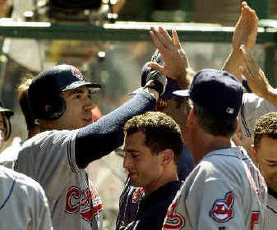 
Travis Hafner of the Indians is congratulated by teammates in the dugout after his third homer and fifth in two days.
 (Associated Press / The Spokesman-Review)