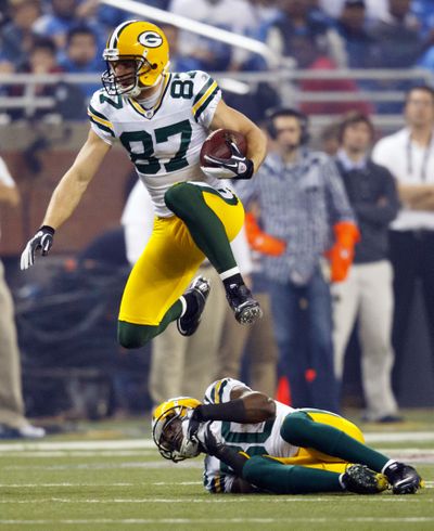 Green Bay’s Jordy Nelson (87) leaps over teammate Donald Driver (80) during the third quarter. (Associated Press)
