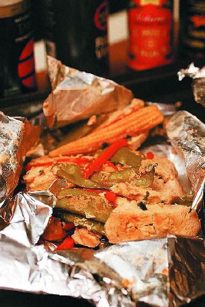 
Ingredients in a packet steam in their own juices, intensifying the flavor and keeping food moist. 
 (Associated Press / The Spokesman-Review)