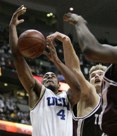 
UCLA's Arron Afflalo has his layup blocked by Texas A&M's Antanas Kavaliauskas in  the first half of the John R. Wooden Classic. 
 (Associated Press / The Spokesman-Review)