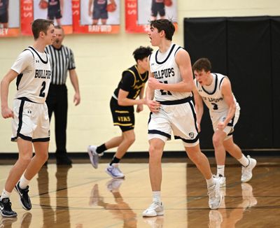 Gonzaga Prep’s Ryan Carney, left, Jackson Mott and Hudson Floyd begin to celebrate their preliminary-round basketball win over Puyallup on Saturday at West Valley High School. (Jesse Tinsley/THE SPOKESMAN-REVI)