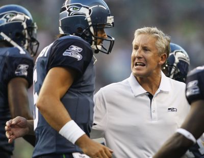 Seattle Seahawks head coach Pete Carroll greets quarterback Charlie Whitehurst on the sidelines during first half. (John Froschauer / Fr74207 Ap)