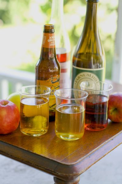 Popular beverages include, from left in foreground, glasses of hard apple cider, apple beer and apple wine. (Associated Press)