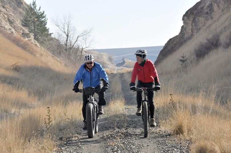 Pat Sprute, left, and Chip Andrus of Spokane cycle on the abandoned railway called the John Wayne Trail near Rosalia. (Rich Landers / The Spokesman-Review)