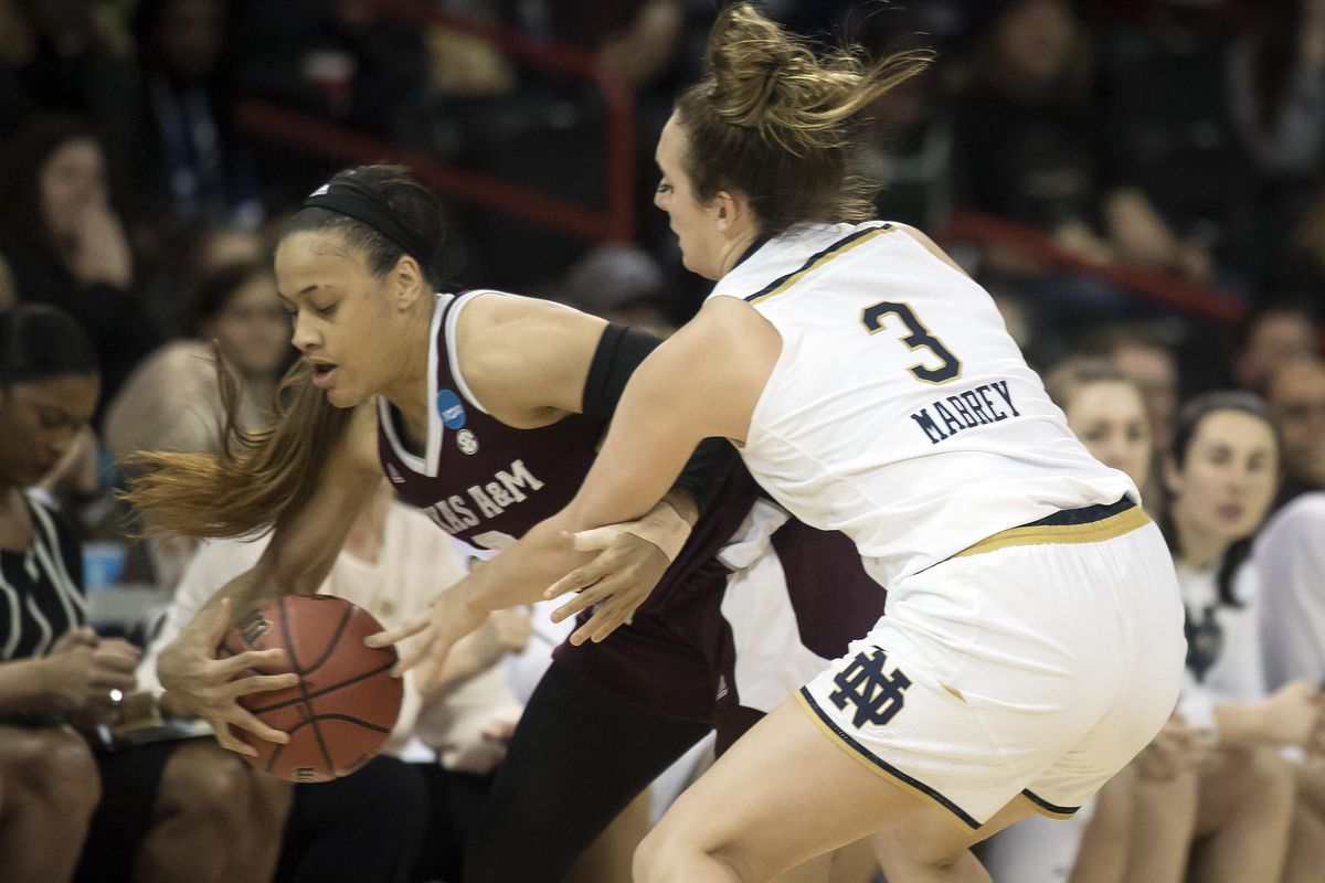 Texas A&M guard Chennedy Carter (3) tries to keep the ball inbounds as Notre Dame guard Marina Mabrey (3) defends during a NCAA regional semi-final basketball game, Sat., March 24, 2018, in the Spokane Arena. (Colin Mulvany / The Spokesman-Review)