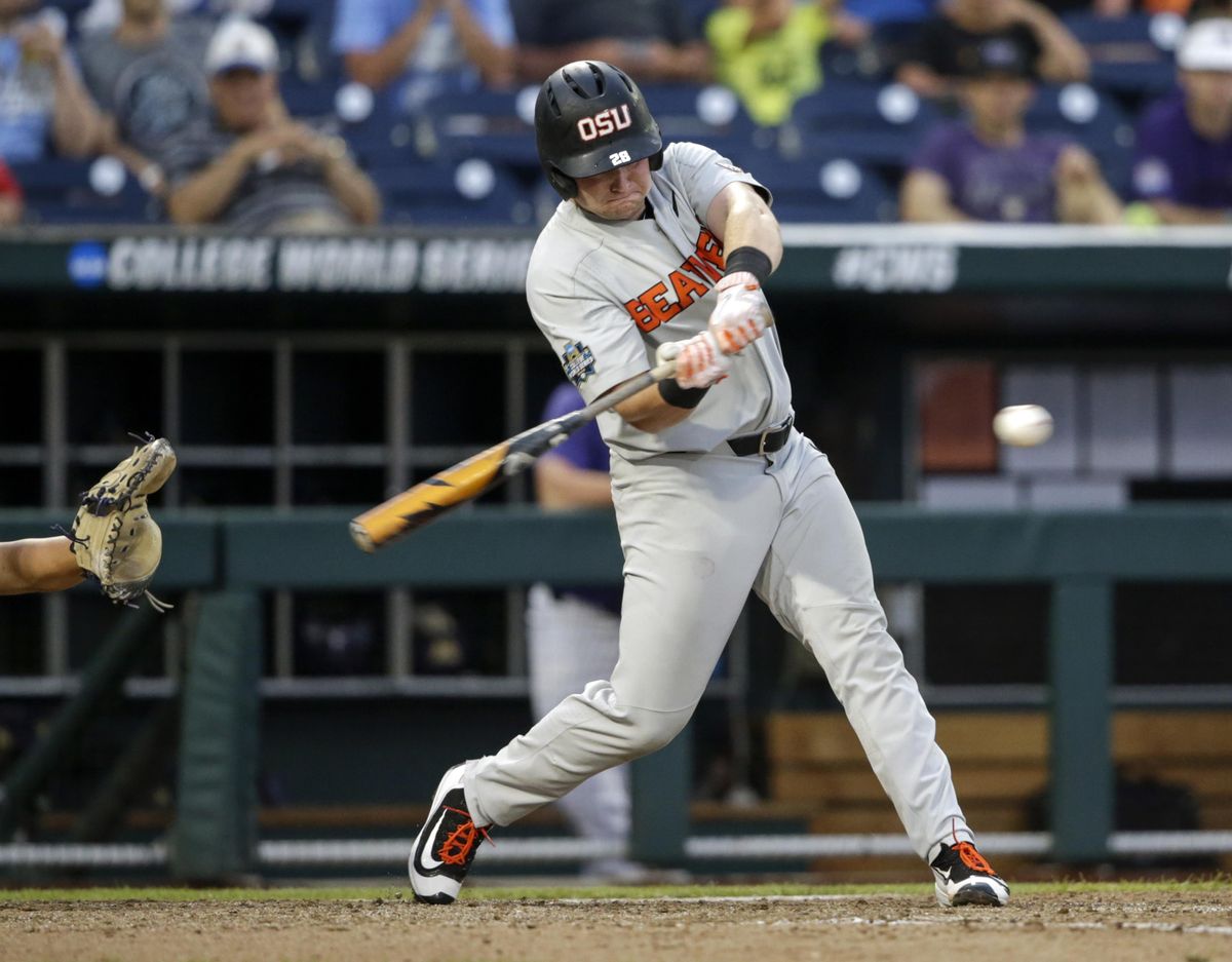 Oregon State designated hitter Kyle Nobach (28) hits a three-run home run in the seventh inning of an NCAA College World Series baseball elimination game against Washington in Omaha, Neb., Monday, June 18, 2018. Oregon State won 14-5. (Nati Harnik / Associated Press)