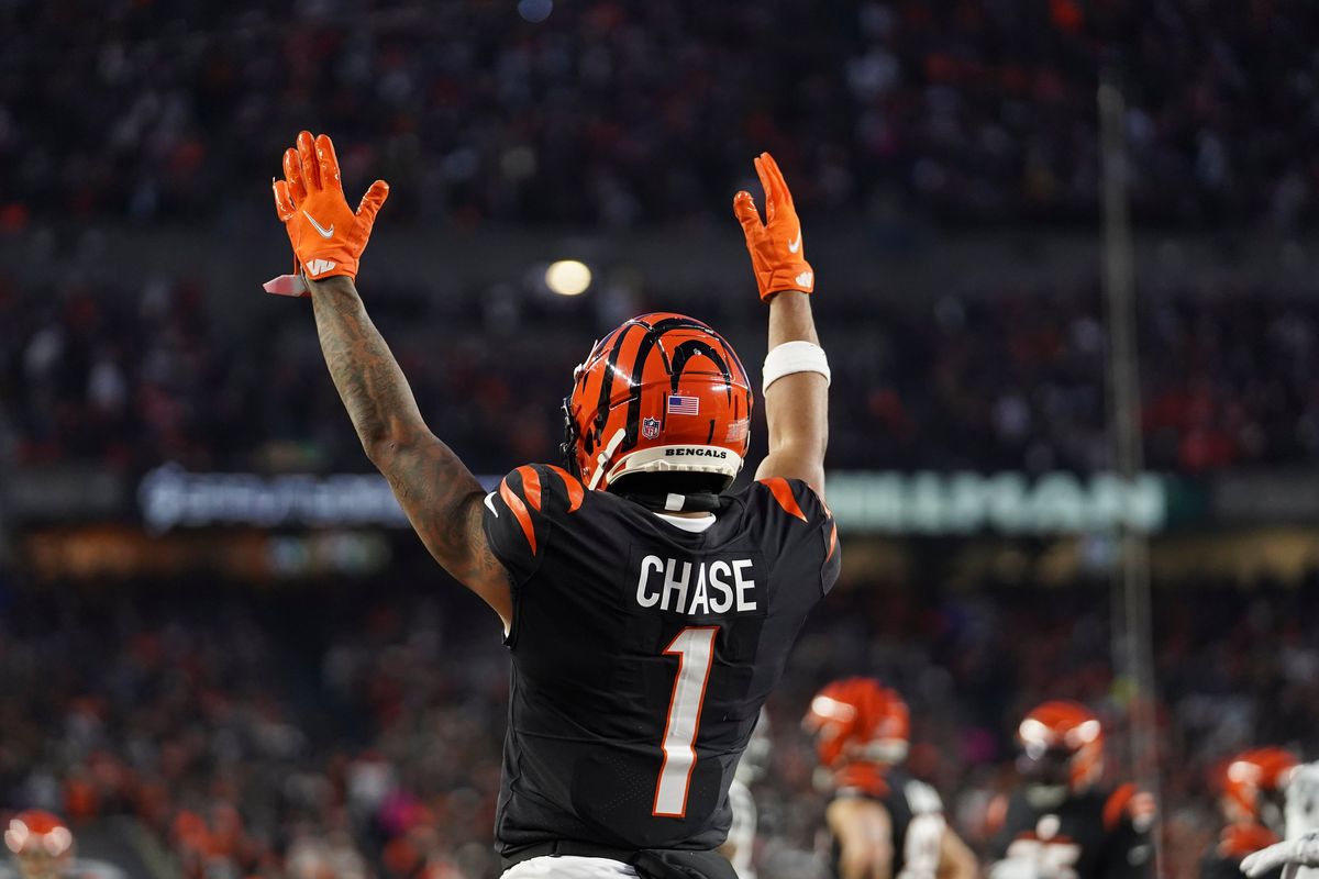 Cincinnati Bengals' Ja'Marr Chase signals for a touchdown on a ball caught by Tyler Boyd during the first half of an NFL wild-card playoff football game against the Las Vegas Raider, Saturday, Jan. 15, 2022, in Cincinnati.  (Jeff Dean)