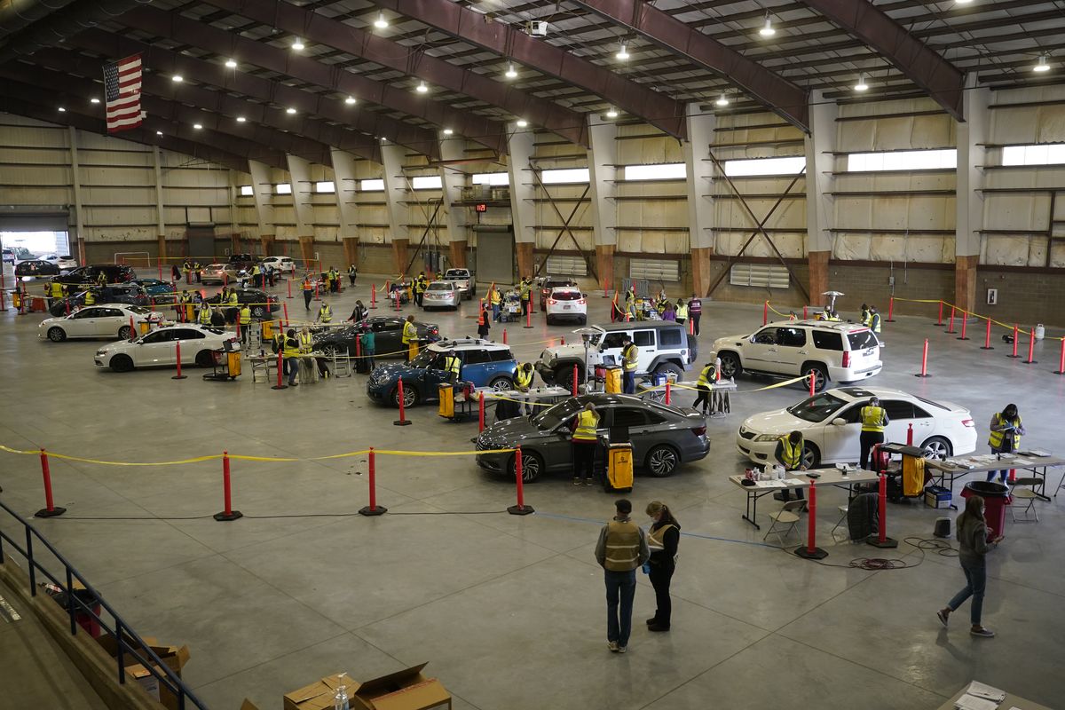 Cars pull in to nursing stations for the COVID-19 vaccine roll out at the Davis County Legacy Center in Farmington, Utah, on  Jan. 12, 2021.  (Rick Bowmer/Associated Press)