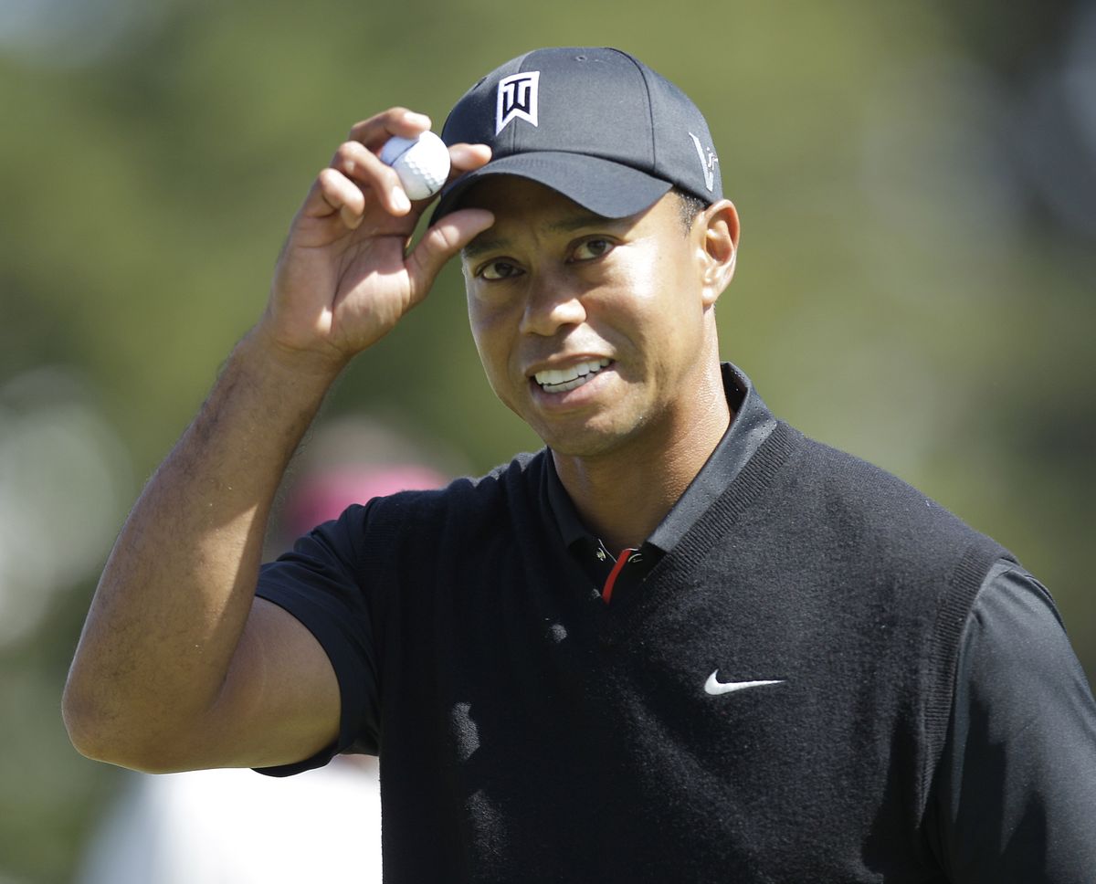 U.S. Open co-leader Tiger Woods reacts after birdieing the 10th hole Friday. (Associated Press)