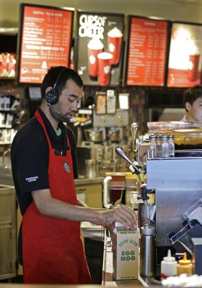 Barista Jay Rapp prepares an eggnog latte last week at a Starbucks in Seattle. (Associated Press)