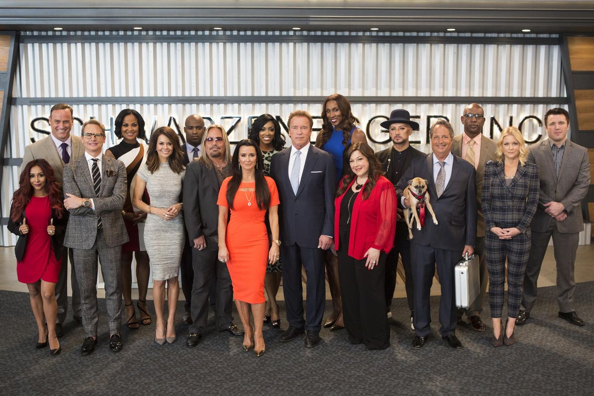 This image released by NBC shows the cast of "The New Celebrity Apprentice," back row from left, Matt Iseman, Laila Ali, Ricky Williams, Porsha Williams, Lisa Leslie, Boy George, Eric Dickerson, Chael Sonnen, and front row from left, Nicole Polizzi, Carson Kressley, Brooke Burke, Vince Neil, Kyle Richards, Arnold Schwarzenegger, Carnie Wilson, Jon Lovitz and Carrie Keagan in Los Angeles. The new season debuts on Monday. (Luis Trinh / NBC)