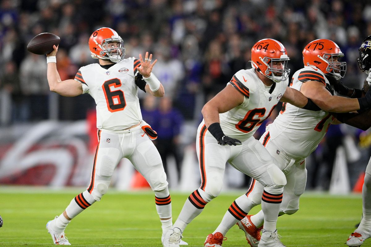 Cleveland Browns center JC Tretter (64) and guard Joel Bitonio block as quarterback Baker Mayfield (6) throws a pass against the Baltimore Ravens during the first half of an NFL football game, Sunday, Nov. 28, 2021, in Baltimore.  (Nick Wass)