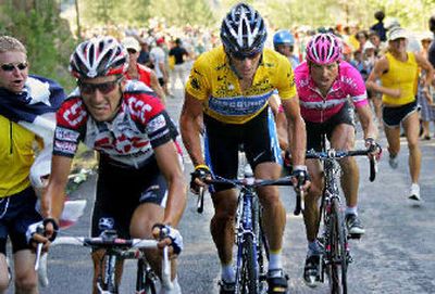 
Overall leader Lance Armstrong, center, rides between Ivan Basso, left, and Jan Ullrich. 
 (Associated Press / The Spokesman-Review)