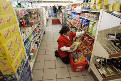 
Marta Zepeda stocks shelves at a 7-Eleven in downtown Los Angeles. 7-Eleven's grocery sales have risen 12 percent to 13 percent in the past year.Associated Press
 (Associated Press / The Spokesman-Review)