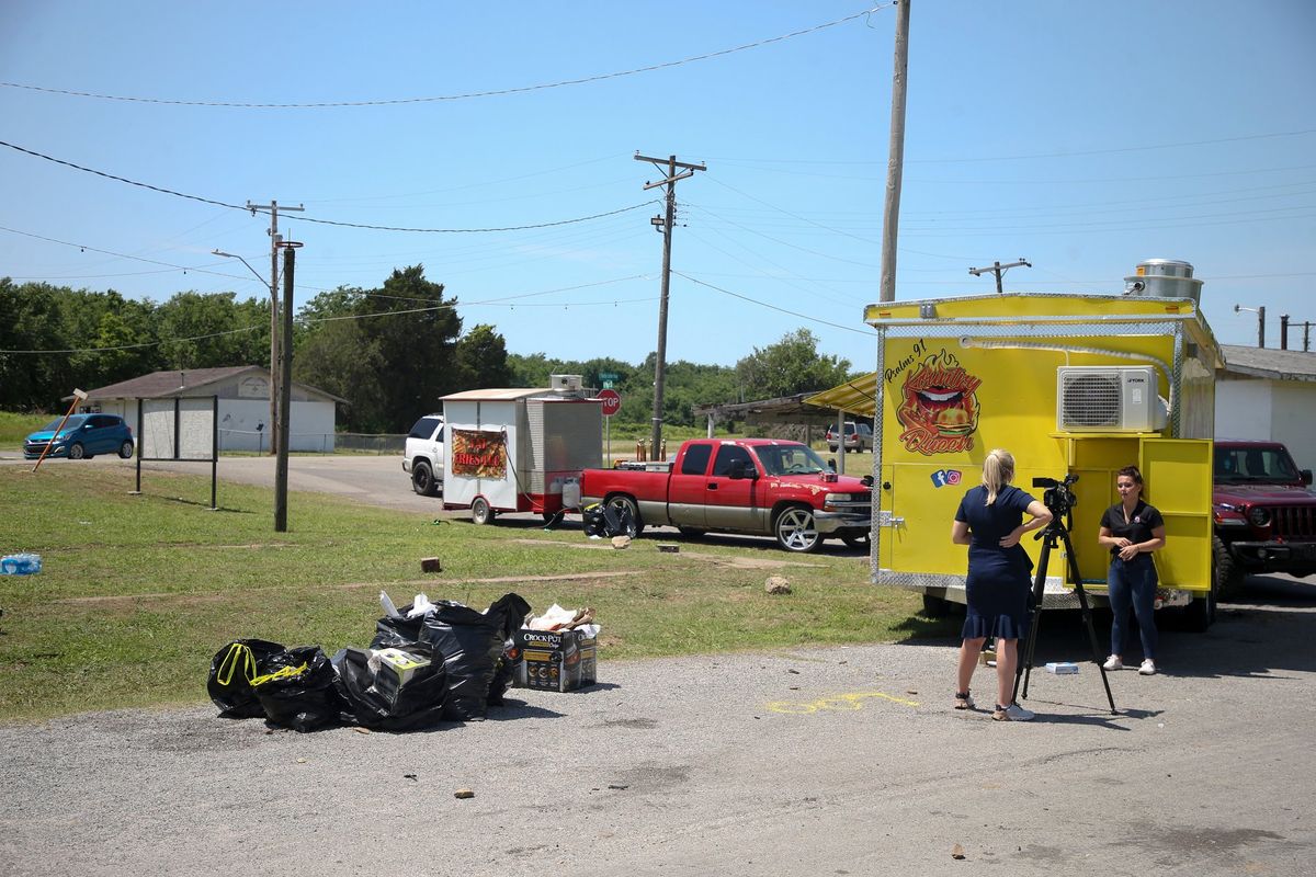 News crews film at the scene of a fatal shooting that happened at a Memorial Day event in Taft, Okla., on Sunday, May 29, 2022.  (Ian Maule)