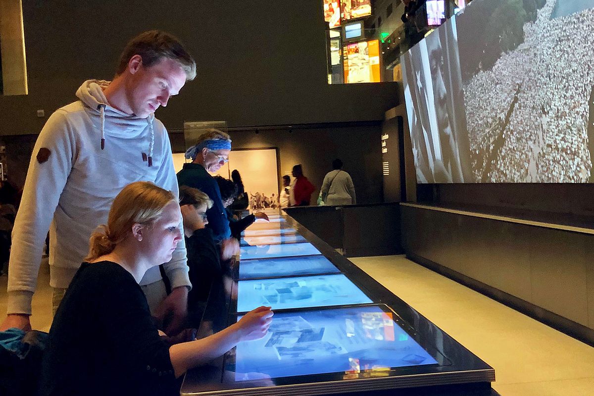 Visitors scroll through an interactive display about the civil rights movement at the National Museum of African American History & Culture in Washington, D.C.  (Leslie Kelly)