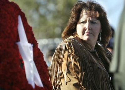 
Roberta Stewart glances at a wreath with the Wiccan symbol during a ceremony Saturday in Fernley, Nev. 
 (Associated Press / The Spokesman-Review)