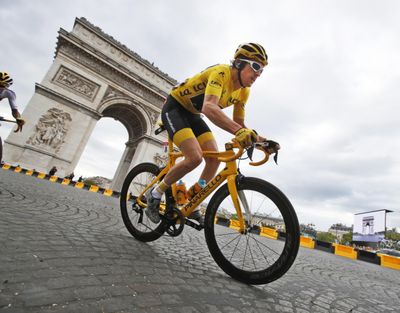 Tour de France winner Britain's Geraint Thomas, wearing the overall leader's yellow jersey, passes the Arc de Triomphe during the twenty-first stage of the Tour de France cycling race over 72.1 miles with start in Houilles and finish on Champs-Elysees avenue in Paris, France, Sunday July 29, 2018. (Christophe Ena / Associated Press)