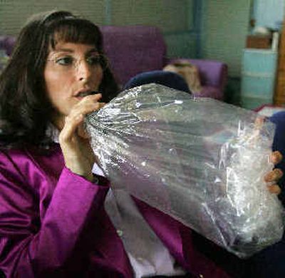
Angel Raich inhales vaporized marijuana at her home in Oakland, Calif., on Monday. Federal authorities may prosecute sick people whose doctors prescribe marijuana to ease pain, the U.S. Supreme Court ruled.
 (Associated Press / The Spokesman-Review)