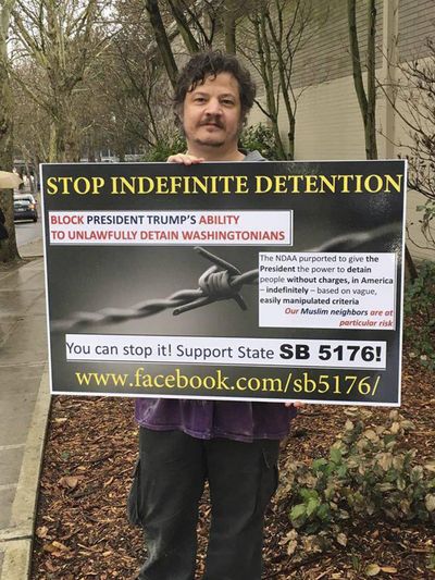In this Feb. 19, 2017, photo provided by lawyer Venkat Balasubramani, Richard L. Rynearson III, of Bainbridge Island, Wash., poses while demonstrating in favor of a bill before the Washington state Legislature in Seattle. Rynearson, a retired Air Force major, is asking a federal court to declare Washington state's cyberstalking law unconstitutional, saying he's been threatened with prosecution – and up to a year in jail – for repeatedly making online posts that criticize a community activist. (Venkat Balasubramani / Associated Press)