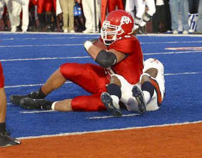 Fresno State's Stephen Spach rolls over Virginia's Tony Franklin and into the end zone for the winning TD in overtime.
(Associated Press / The Spokesman-Review)